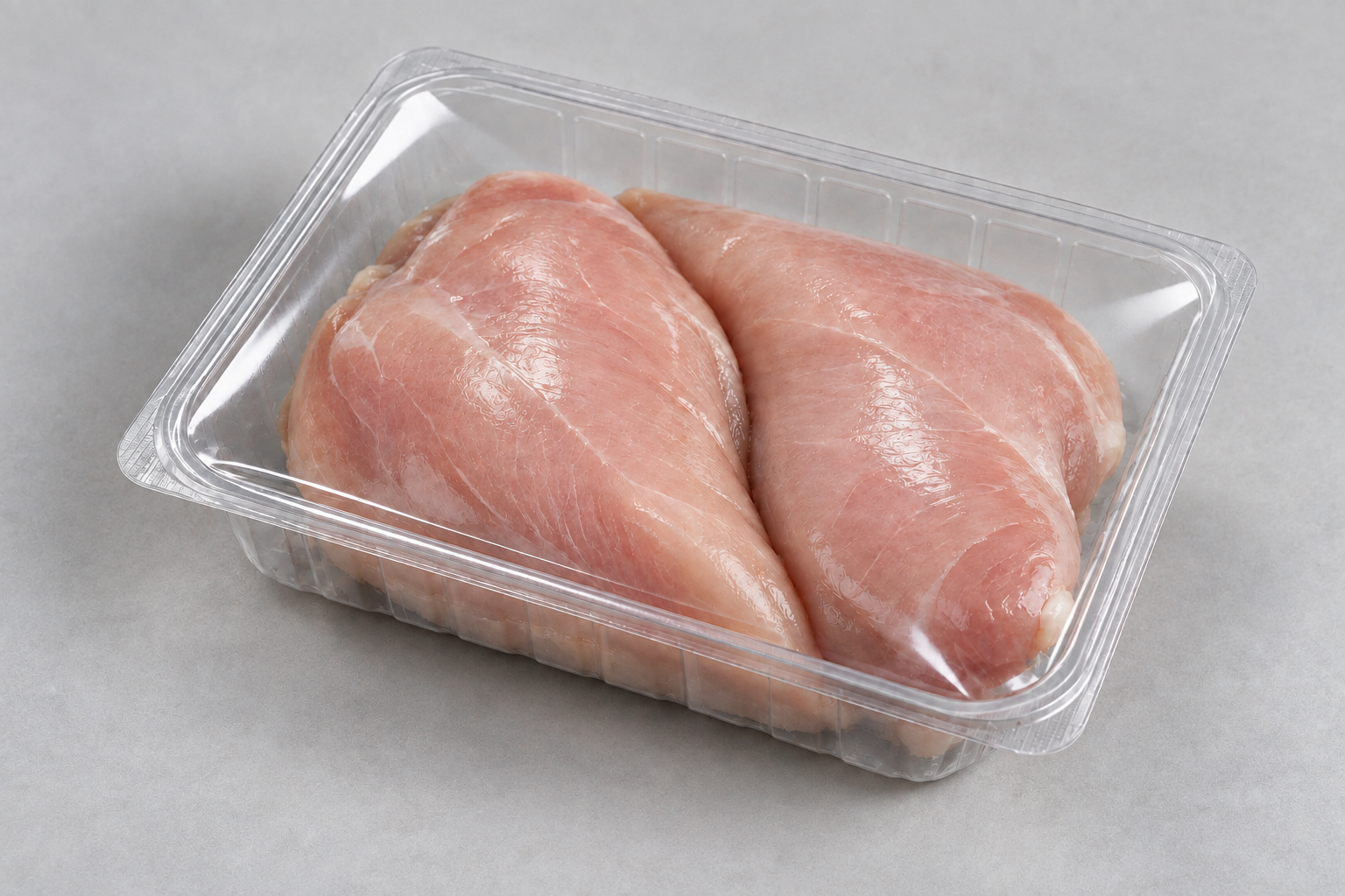 Chicken breasts in a clear tray with smooth, transparent lidding film